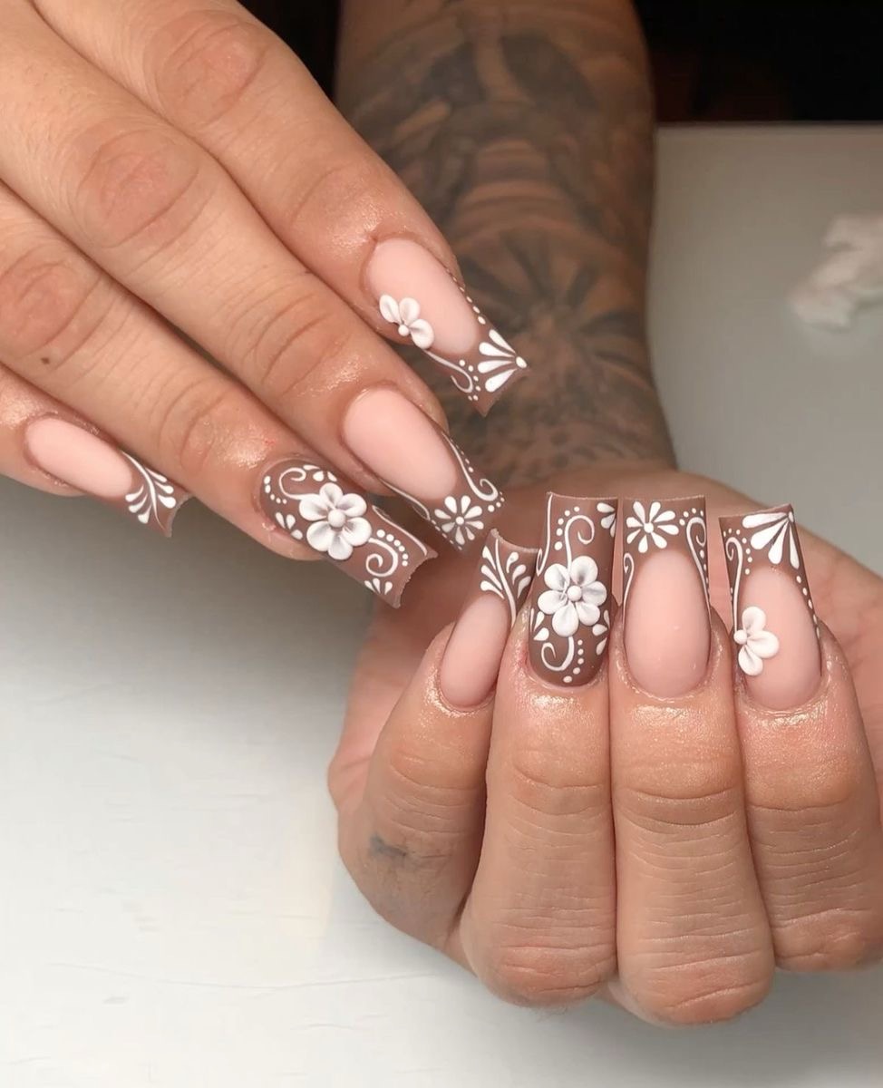 Brown floral nail art with white accents
